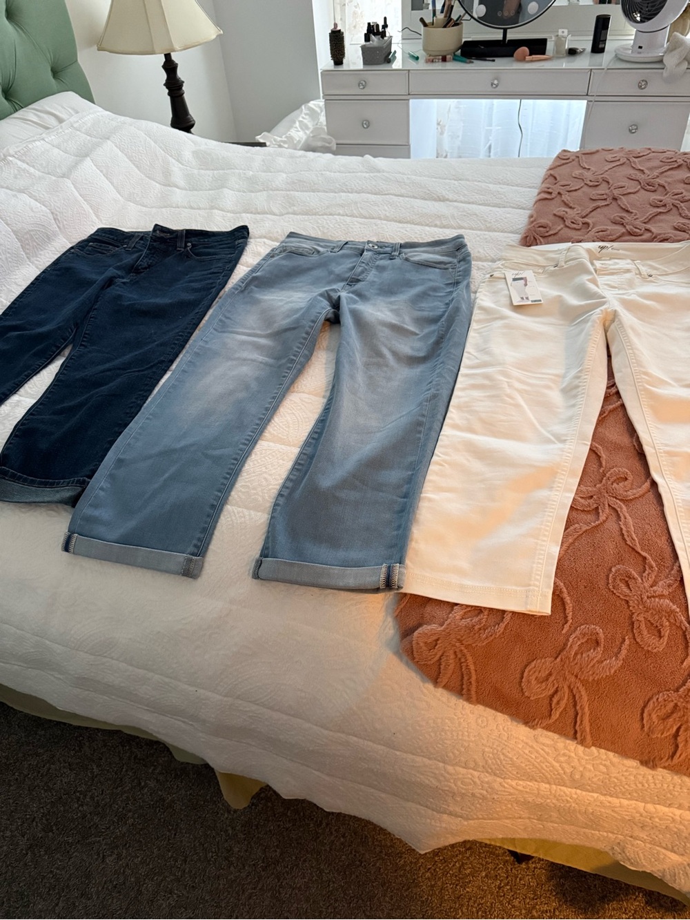 Bundle of women’s cropped jeans 1 dark denim. 1 light denim and one white .